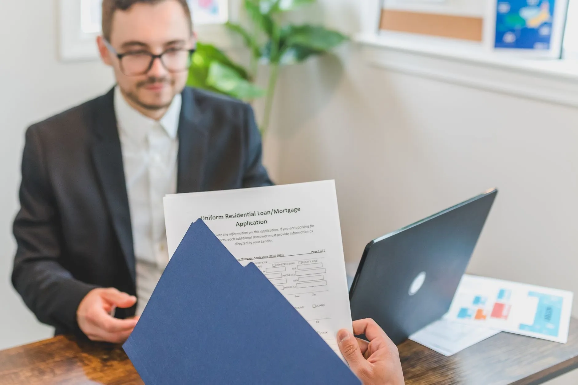 SBA loan documents and financial regulations on a professional desk