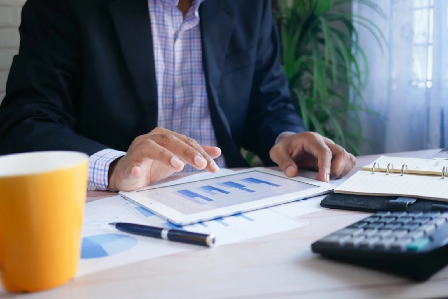 Business professional reviewing regulatory loan documents at a desk