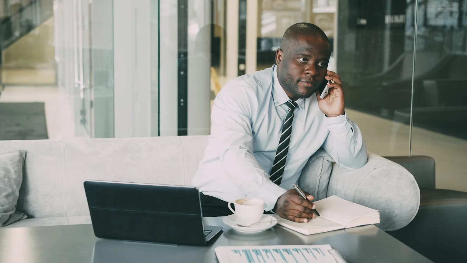 Professional in business attire checking phone at modern fitness studio