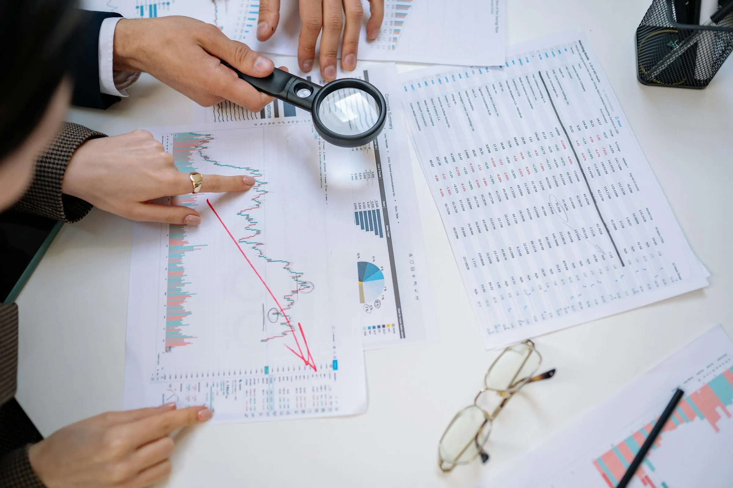 Business professionals examining financial documents for detailed analysis