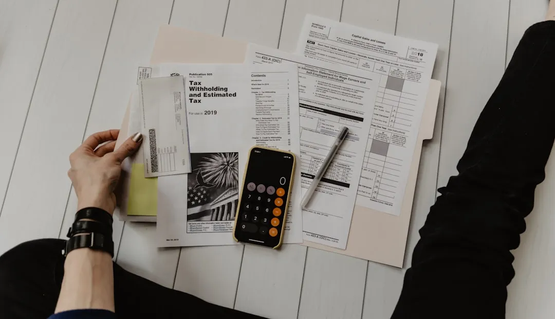Person reviewing financial documents with calculator for franchise investment planning