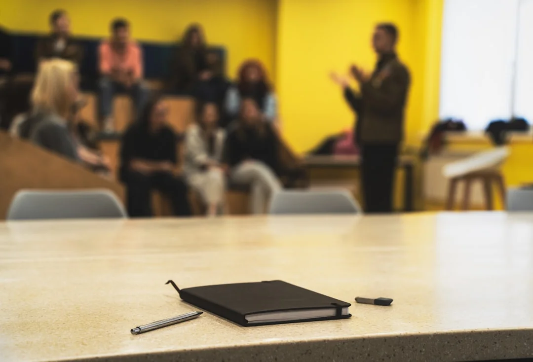 Professional taking notes during a corporate presentation