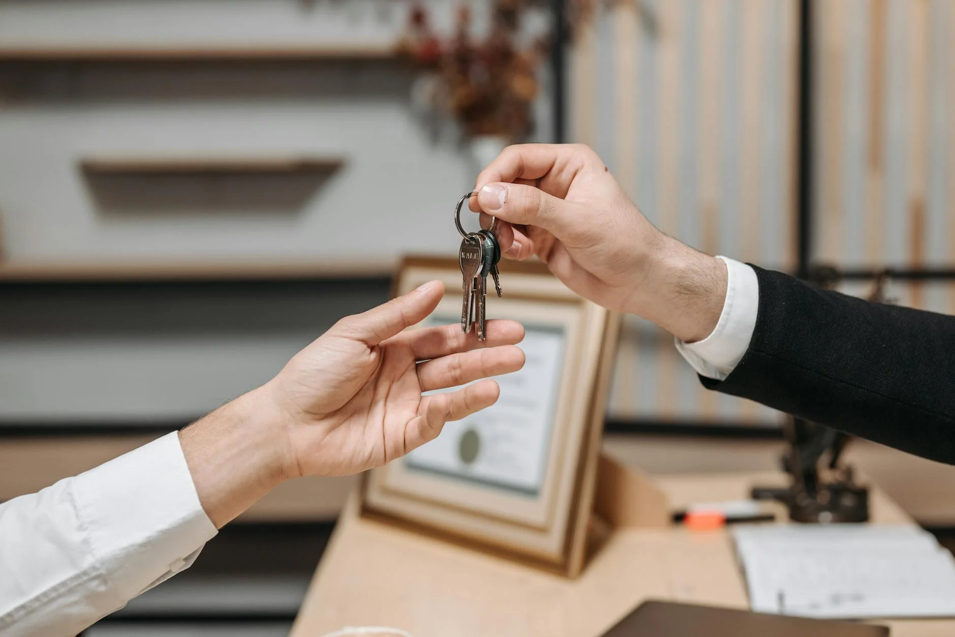 Business professional handing over keys during commercial property transaction
