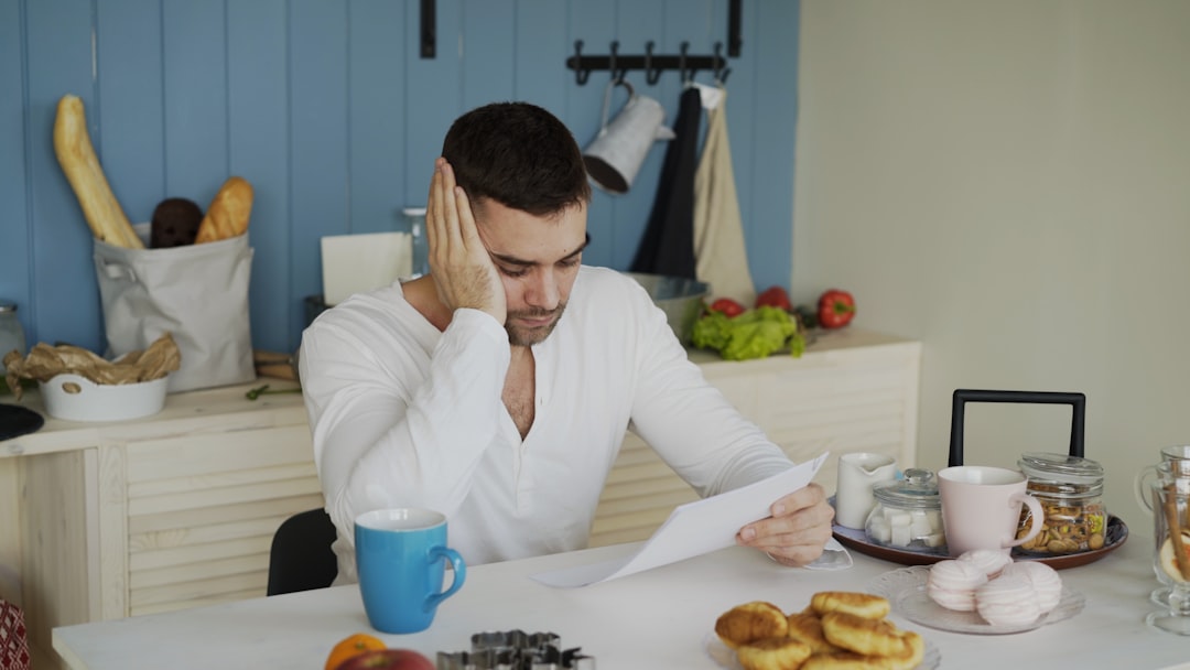 Business owner reviewing financial documents under stress