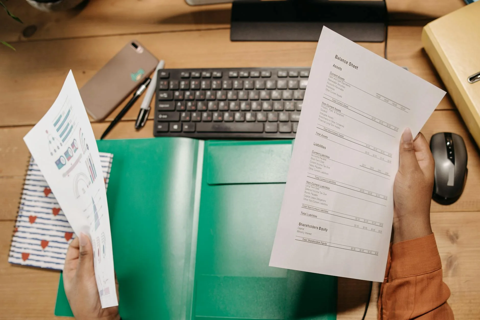 Professional reviewing financial statements at corporate office desk