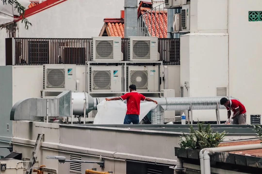 Commercial HVAC unit being inspected on a rooftop
