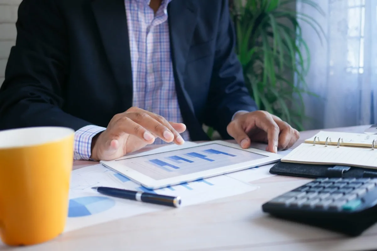 Business owner reviewing financial spreadsheet with monthly revenue and fee calculations