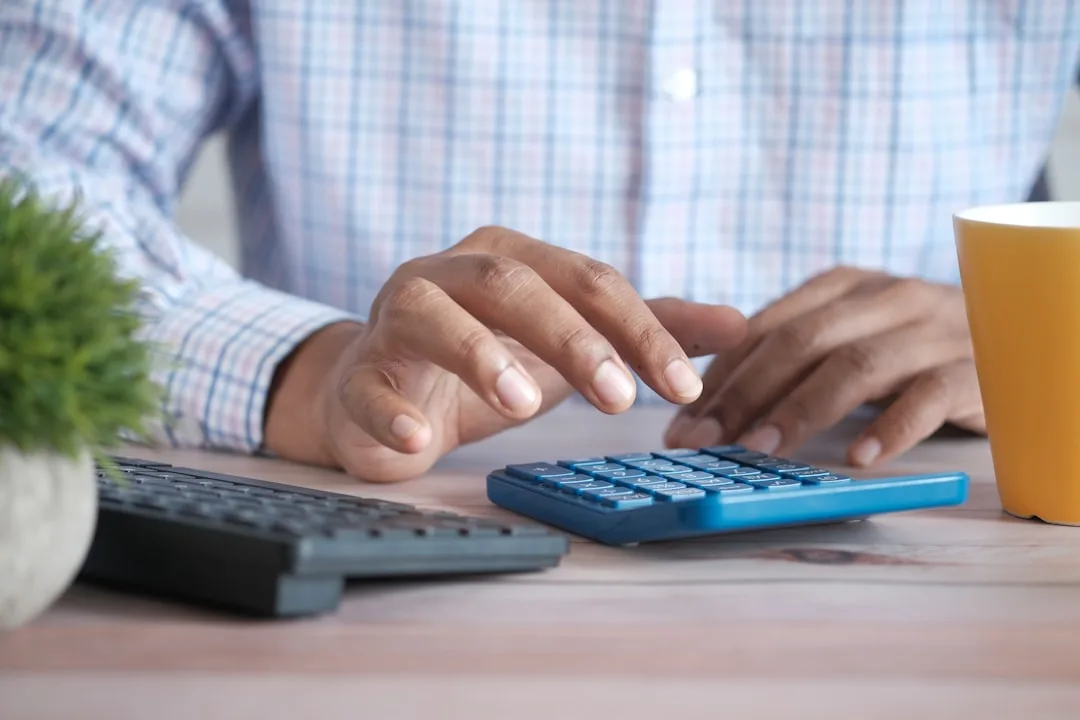 Financial analysis spreadsheet with calculator showing debt service calculations