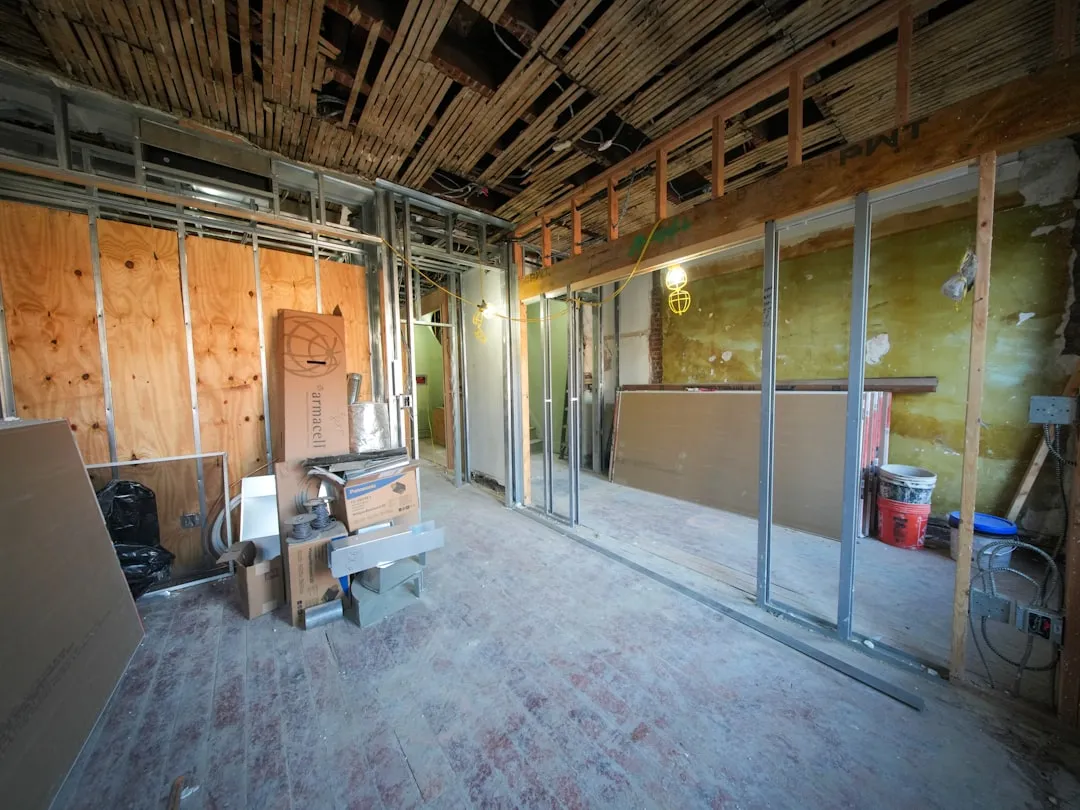 Empty commercial retail space during build-out phase with exposed construction